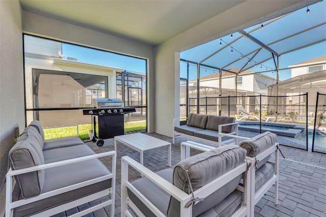 view of patio featuring a lanai, a grill, an outdoor pool, and an outdoor hangout area