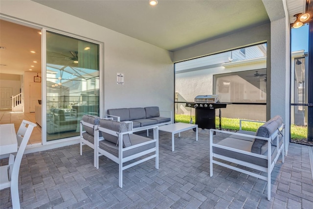 sunroom / solarium featuring ceiling fan