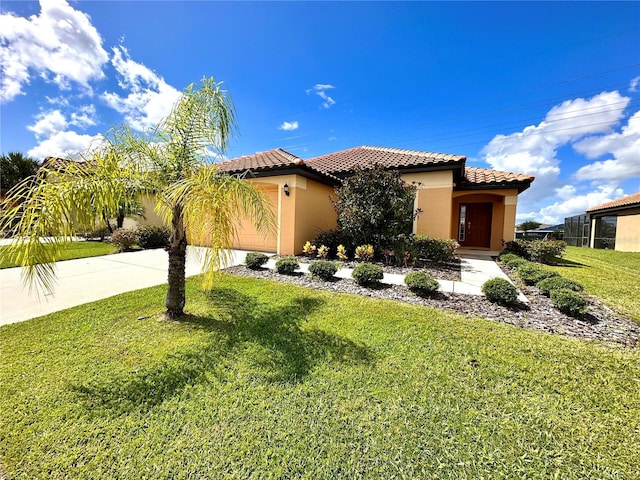 mediterranean / spanish house with driveway, a tiled roof, an attached garage, a front lawn, and stucco siding