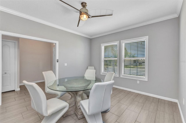 dining room with crown molding, baseboards, and ceiling fan