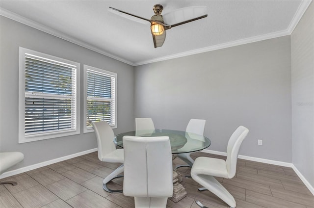 dining room featuring wood tiled floor, ornamental molding, baseboards, and ceiling fan