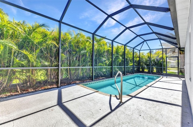 outdoor pool with a lanai and a patio area
