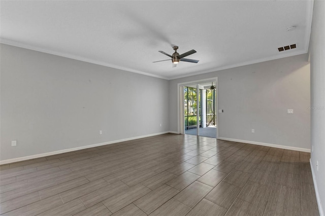 unfurnished room with crown molding, a ceiling fan, wood finished floors, baseboards, and visible vents