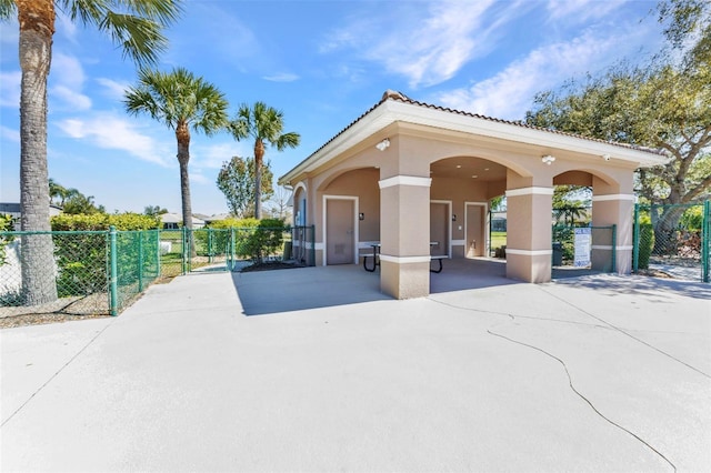 view of community featuring a gate, fence, and a patio area