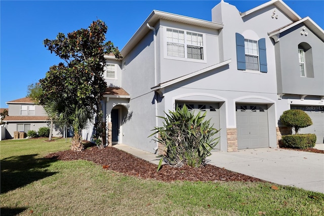 view of front of home featuring an attached garage, stucco siding, concrete driveway, a front lawn, and stone siding