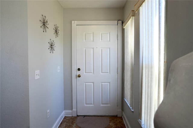 entryway featuring baseboards