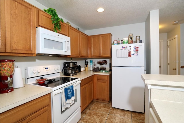 kitchen featuring white appliances, a textured ceiling, brown cabinets, and light countertops