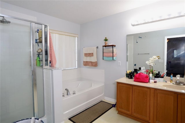 full bathroom featuring a shower stall, vanity, and a garden tub