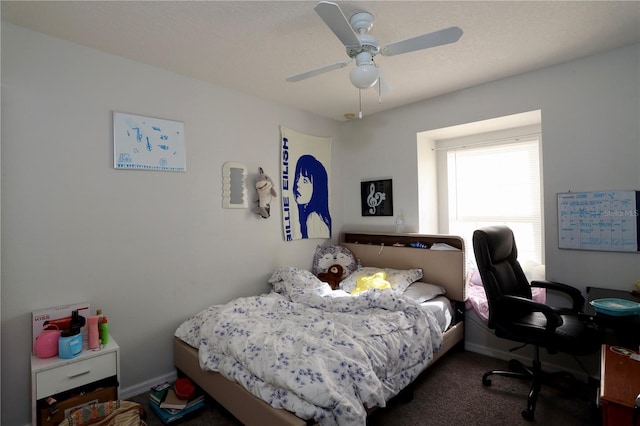 carpeted bedroom with baseboards and ceiling fan