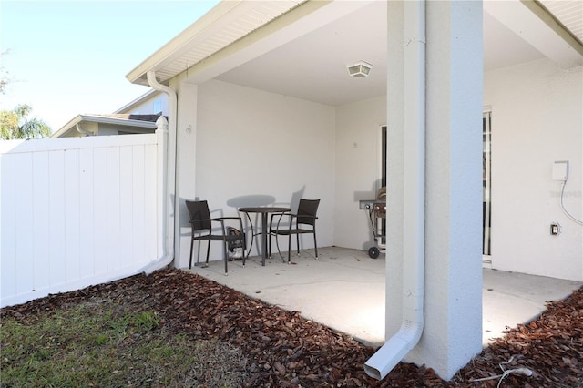 view of patio featuring fence