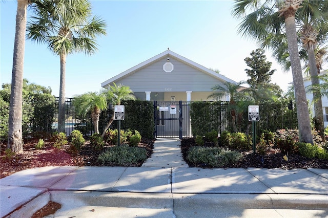 view of front of home with fence and a gate