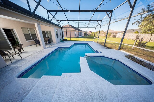 view of swimming pool with a patio area, a lawn, a pool with connected hot tub, and a lanai