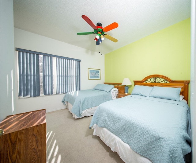 carpeted bedroom with a textured ceiling and ceiling fan