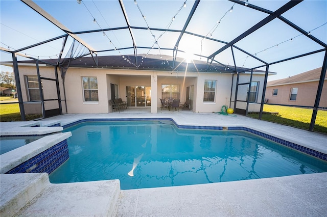 view of swimming pool with a patio area, glass enclosure, a pool with connected hot tub, and a yard