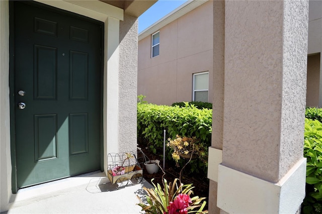 view of exterior entry with stucco siding