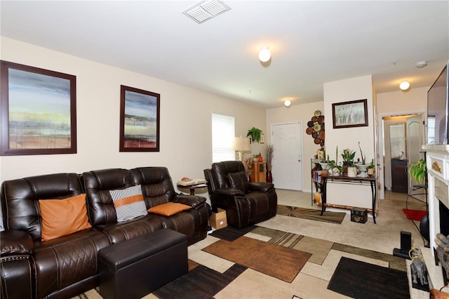 tiled living area featuring visible vents and a fireplace