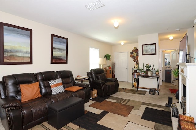 living room with light carpet, visible vents, a fireplace with flush hearth, and light tile patterned floors