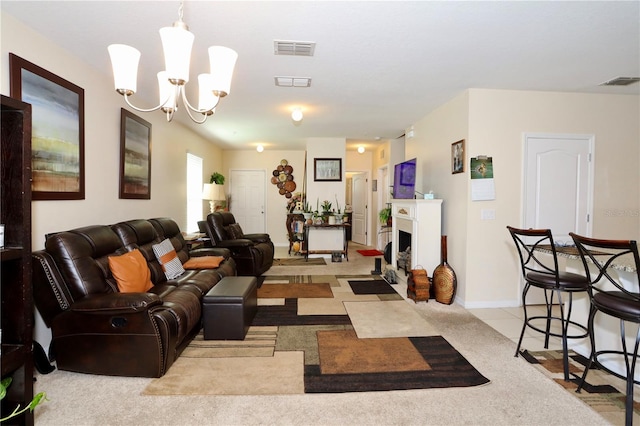 living room featuring visible vents, a fireplace with flush hearth, and a chandelier