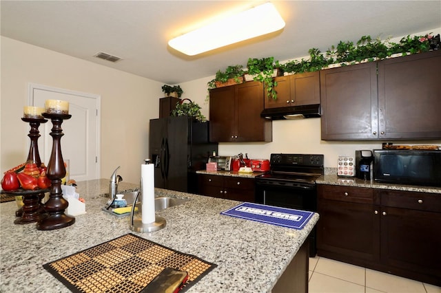 kitchen featuring visible vents, a sink, black appliances, dark brown cabinets, and under cabinet range hood