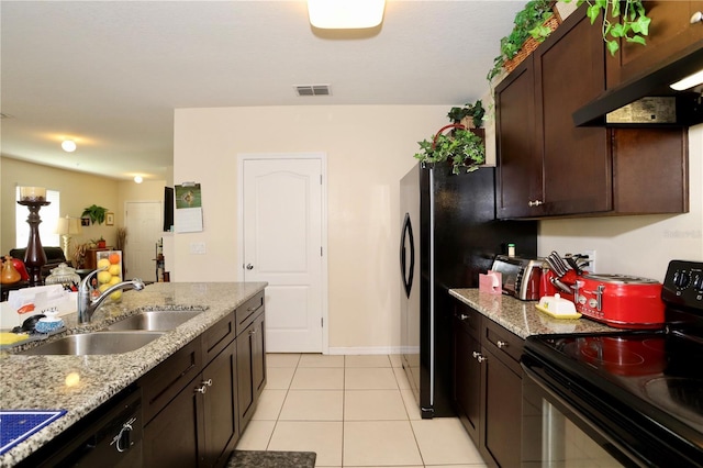 kitchen featuring visible vents, black appliances, a sink, dark brown cabinetry, and light tile patterned flooring