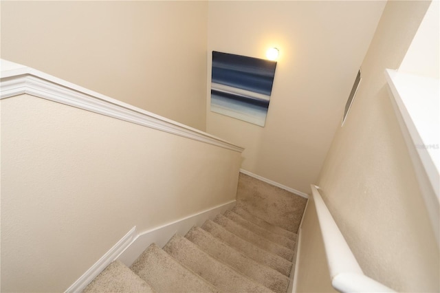 stairs with baseboards and carpet floors