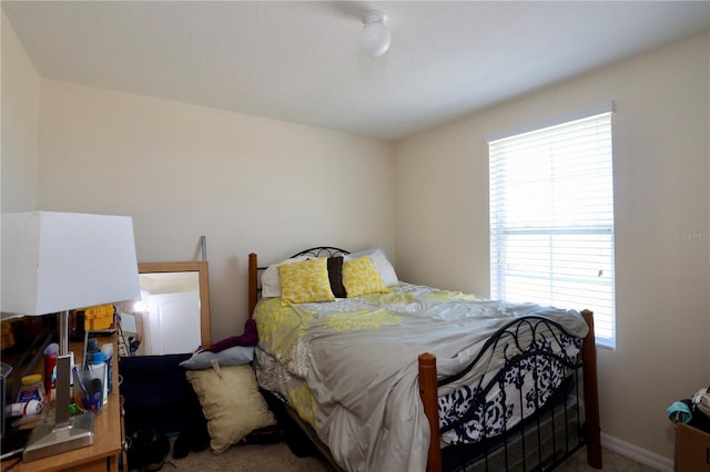 bedroom featuring baseboards and carpet floors