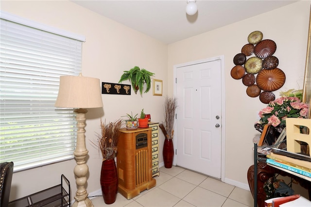 entryway featuring light tile patterned floors and baseboards