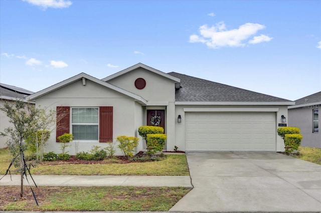 ranch-style house featuring stucco siding, an attached garage, concrete driveway, and roof with shingles