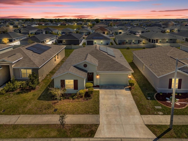 aerial view at dusk featuring a residential view