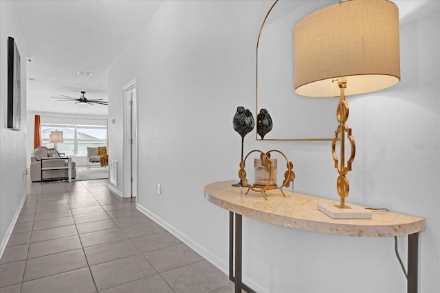 hall featuring baseboards, tile patterned flooring, and visible vents