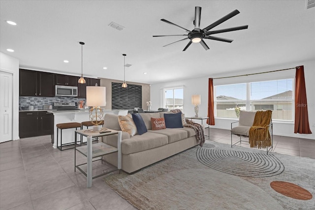 living room featuring ceiling fan, recessed lighting, light tile patterned flooring, and visible vents