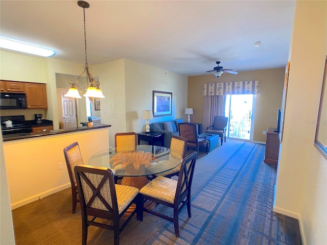 dining room with ceiling fan and baseboards