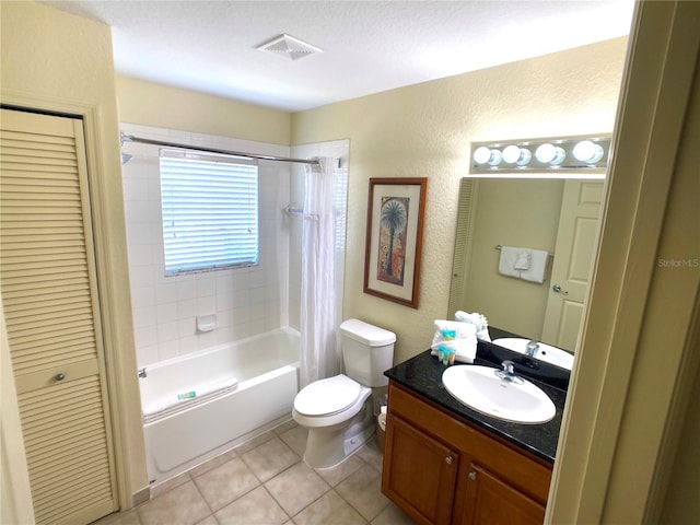 full bath featuring visible vents, toilet, tile patterned floors, shower / bath combo with shower curtain, and vanity