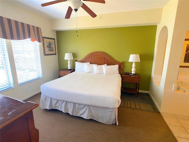 bedroom with tile patterned flooring, baseboards, and ceiling fan