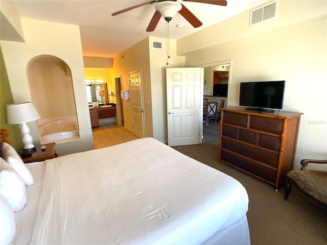 bedroom featuring visible vents, ceiling fan, and ensuite bath