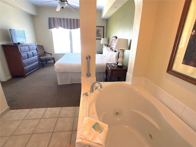 bedroom featuring tile patterned flooring, a ceiling fan, carpet flooring, and a textured wall