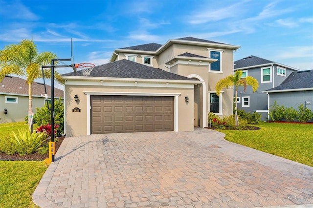 view of front facade featuring a shingled roof, an attached garage, decorative driveway, a front lawn, and stucco siding