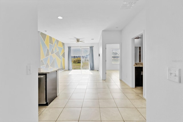 hallway with recessed lighting, baseboards, visible vents, and light tile patterned flooring