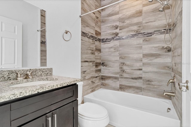 bathroom featuring toilet, vanity, and bathing tub / shower combination