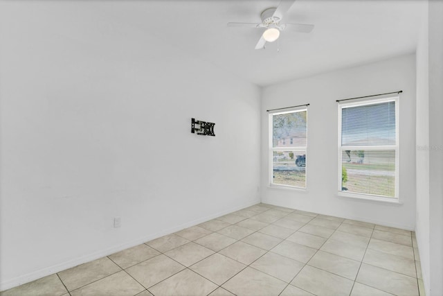 empty room featuring ceiling fan and light tile patterned floors