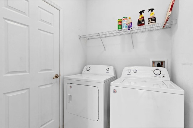 clothes washing area with laundry area and washer and dryer