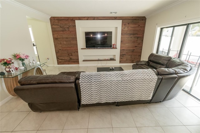 living area with baseboards, visible vents, tile patterned floors, crown molding, and wood walls