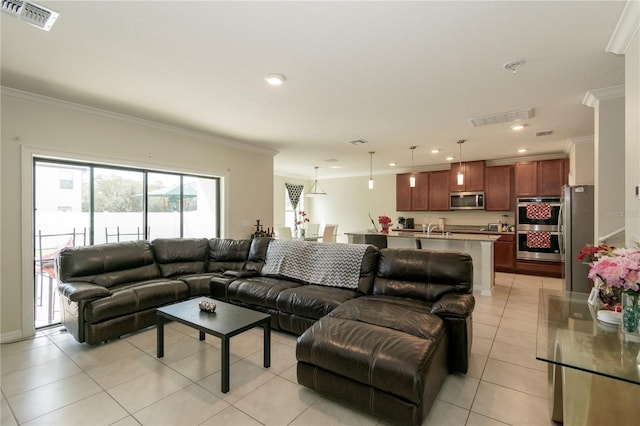 living area with light tile patterned floors, visible vents, crown molding, and recessed lighting