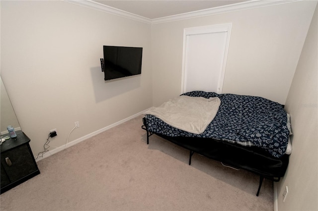 bedroom featuring carpet, baseboards, and crown molding