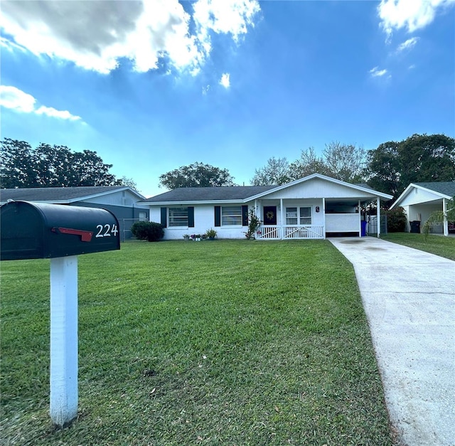 single story home with a carport, a front yard, and driveway