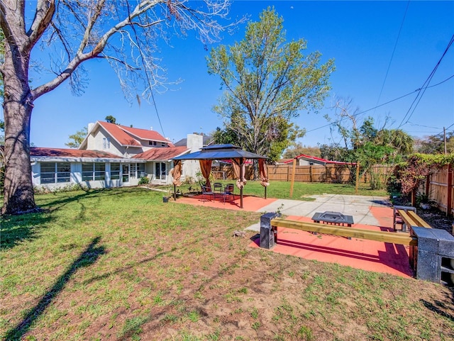 view of yard featuring a patio area, a fenced backyard, and a gazebo