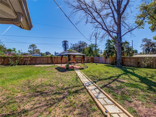 view of yard featuring a fenced backyard, a patio, and a gazebo