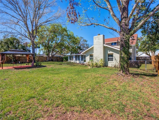 view of yard featuring a gazebo and a fenced backyard