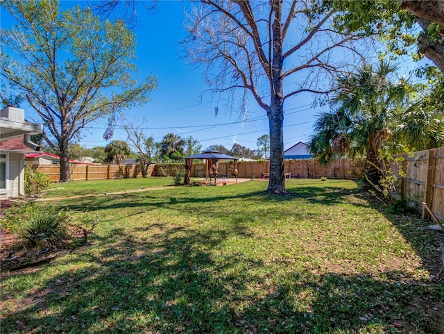 view of yard featuring a fenced backyard and a gazebo