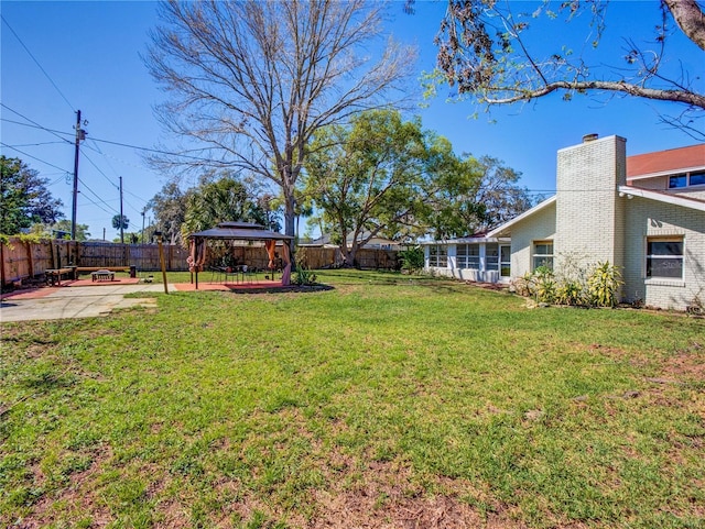 view of yard featuring a gazebo, a patio area, and a fenced backyard